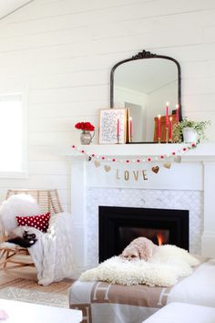 a living room filled with furniture and a fire place under a mirror on the wall