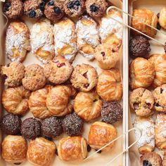 two boxes filled with different types of pastries and cookies on skewers next to each other