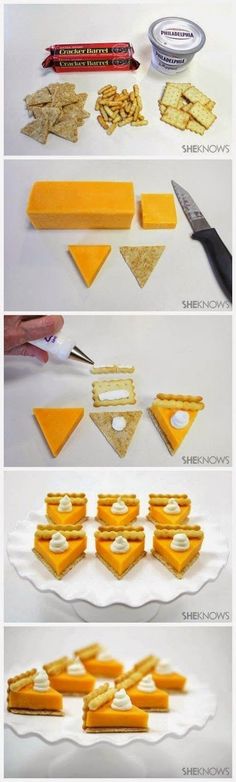 cheese and crackers are arranged in the shape of triangles on white platters