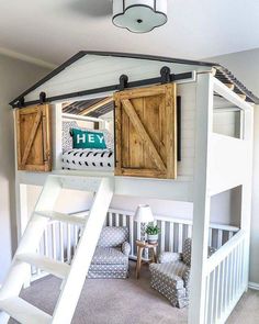 a loft bed with wooden shutters and stairs