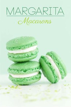 green macaroons with white frosting and sprinkles are stacked on top of each other