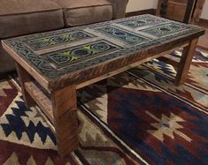 a living room with a couch, rug and coffee table