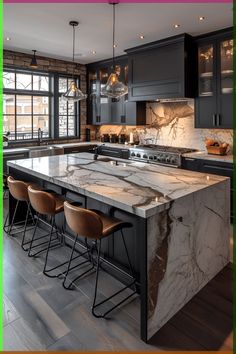 a large kitchen with marble counter tops and bar stools in front of the island