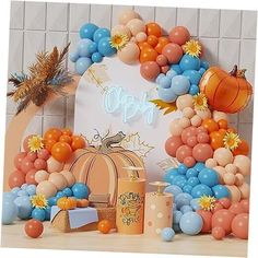 an orange, blue and white balloon arch with balloons