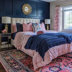 a bedroom with blue walls and pink bedding