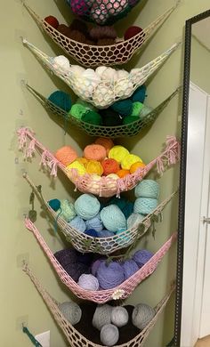 there are several balls of yarn on the wall