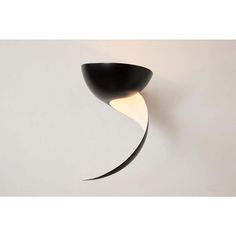 a black and white wall light with a curved design