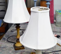 two lamps sitting on top of a table next to each other