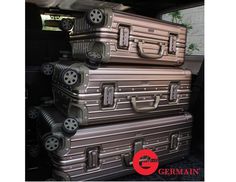 three suitcases stacked on top of each other in the back of a car with wheels