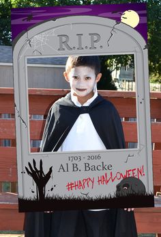 a young boy dressed up as a spider in front of a frame with the words rip on it