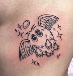 an owl tattoo on the side of a woman's stomach with stars around it