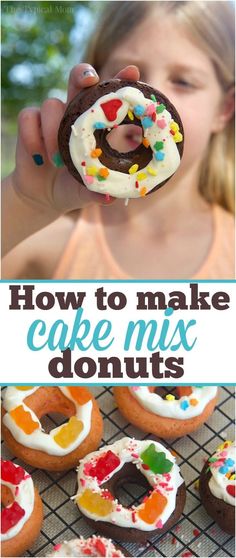 a girl holding up a donut with white frosting and sprinkles