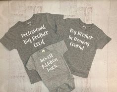 "Set of 3 personalized matching sibling shirts! (wording can be changed, big, middle, sister etc..) Shown in heather gray shirts with custom names! This set shown says Professional big brother, big brother in training, newest addition. {OPTIONS} TO CHANGE TO LONG SLEEVE purchase this link too: https://etsy.me/2VsO6nd NEED AN EXTRA SHIRT? PURCHASE THIS LINK TOO: https://etsy.me/2GQoHM1 {COLORS} Colors will be as shown in the main photo (gray & white) unless another color is requested. ONLY ad Gray Cotton Family Matching T-shirt, Customizable Gray Cotton T-shirt, Customizable Gray Cotton Tops, Matching Sibling Shirts, Matching Tshirts, Middle Sister, Personalized Matches, Sibling Shirts, Big Sister