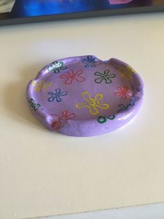 a paper plate with flowers painted on it