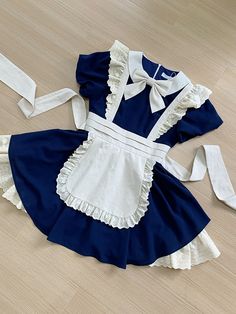 This price includes a dress and a beige bowknot.  Get ready to channel your inner maid with this stunning Dark Blue Lolita Fashion Apron Dress. Complete with a charming bowknot on the neckline, this dress is perfect for anyone looking to add a touch of elegance and whimsy to their wardrobe. Whether you're attending a tea party or simply want to showcase your love for Lolita fashion, this apron dress is sure to turn heads and make you feel like a true fashionista.   	 		 			Size 			S 			M 			L Blue Maid Dress, Fashion Apron, Gothic Skirts, Maid Outfit, Maid Dress, Apron Dress, Art Characters, Drawing Clothes, Outfits With Hats