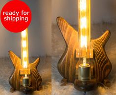 two pictures of a wooden guitar lamp with the same light bulb on each side and an image of it reading ready for shipping