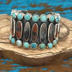 This Fabulous Statement Cuff Bracelet By Federico Jimenez Features Vintage Stones, Including Oval Petrified Wood Pieces That Graduate In Size Toward Each End. Each Side Of The Bracelet Is Adorned With A Border Of Round Natural Turquoise Stones, Ranging In Color From Blue To Green, With Each Stone Individually Bezel Set. The Center Back Of The Bracelet Is Stamped With Federico’s Hallmark And Sterling, Ensuring Its Authenticity. Purchased Directly From Federico Himself, This Exquisite Piece Has A Retail Value Of $2,500. The Inside Measurement Is 5.25” With A 1.25” Gap, Giving A Total Inside Circumference Of 6.5”. The Width At Its Widest Point Is Nearly 1.875”, And The Total Weight Is Statement Cuff Bracelet, Elongated Oval, Natural Turquoise Stone, Hippie Bracelets, Turquoise Bracelet Cuff, Turquoise Cuff, Turquoise Stones, Petrified Wood, Wood Pieces