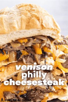 a close up of a sandwich with cheesesteak on it and the words venison phily cheese steak