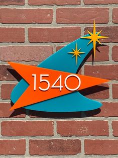 a sign on the side of a brick wall that reads, 150 years old with stars