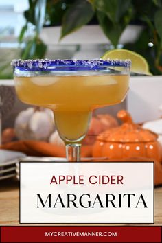 an apple cider margarita sitting on top of a table