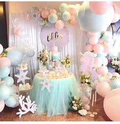 a birthday party with balloons, cake and decorations