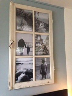 an old window is hung on the wall above a bed with blue walls and white trim