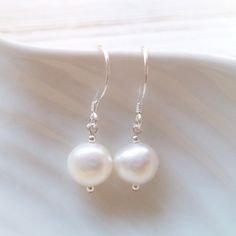 Pearl drop dangle earrings serve as a dainty and elegant accent without overpowering the rest of your outfit making them ideal as part of a bridal outfit or for the bridesmaids at your wedding.  The moment you choose to wear dainty pearl drop earrings, either basic or statement-like, it's best to tie up your hair in a bun or a more sophisticated updo to let the earrings stand out and enhance your facial features.  FEATURES: * real cultured freshwater pearls * ivory white with beautiful lustre * White Drop Earrings For Bridesmaid Gift, Delicate White Pearl Earrings For Bridesmaids, Round Teardrop Earrings For Wedding, White Teardrop Hypoallergenic Bridal Earrings, Elegant White Earrings For Bridesmaid Gift, Classic White Teardrop Sterling Silver Earrings, Classic White Sterling Silver Teardrop Earrings, Hypoallergenic White Teardrop Bridal Earrings, White Hypoallergenic Earrings For Bridesmaid Gift