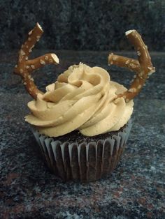 a cupcake with frosting and pretzels on top