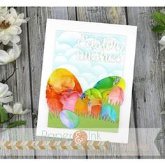 an easter card with watercolored eggs on it and flowers in the foreground