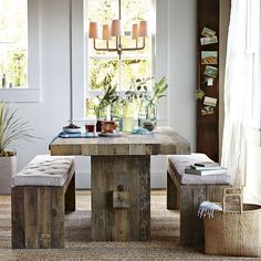 a table with two benches in front of a window