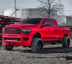 a red ram truck is parked on the gravel