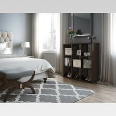 a bedroom with gray walls and white furniture