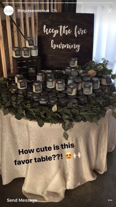 a table topped with lots of candles next to a sign