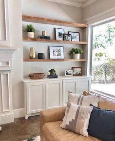 a living room filled with furniture next to a window