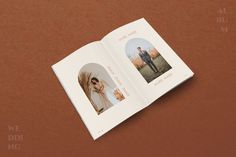 an open photo book on a brown surface with two photos in the middle and one image inside