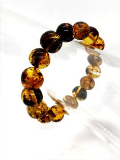 Baltic Amber Bracelet Material: 100% Natural Baltic Amber  Amber with natural imperfections Weight: 23,1 gr. (0.81 oz) Beads round-oval (not perfect round shape) Every single bead made by hand  100% Handmade Comes from Baltic sea region Beads on elastic rubber Around wrist: 17,5 cm (6.88 inch) The biggest bead: 15 mm (0.59 inch) The smallest bead: 12 mm (0.47 inch)    Is this one not for You?              Then Click here to see my other items!     Have any questions regarding the item?  Please feel free to contact us through eBay messages!      Have any problems regarding your purchase? Please contact us and we guarantee to solve it!    Have already bought the item? Thank You! Your package will be shipped in 1 day after payment receiving   Is your location far away from Lithuania? Not a pr Single Bead, Oval Beads, Amber Bracelet, Natural Amber, Handcrafted Artisan Jewelry, Amber Beads, Baltic Sea, Not Perfect, Baltic Amber