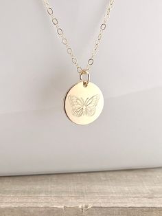 "14k Solid Gold or Gold Filled Butterfly Necklace - 1/2\" custom engraved (please see ALL pictures for accurate sizing references) * Your choice of 14k solid gold or gold filled  * Pendant is 1/2\" (12.7 mm) in size, engraved with a butterfly design on a shiny finish * 14k gold or gold filled 1.5mm flat cable chains are available in 16, 18, and 20\" lengths * Necklaces/Pendants are packaged in a gift box and placed in an organza gift bag ready for gift giving * Gift messages and wrapping are als Hand Stamped Sterling Silver Necklaces In Yellow Gold, 14k Gold Stamped Jewelry As Gift, Etched Round Disc Jewelry As Gift, Gold Sterling Silver Charm Necklaces With Engraving Option, Minimalist Etched Jewelry For Keepsake, Etched Medallion Jewelry For Commemoration, Gold Stamped Sterling Silver Charm Necklaces, Gold Sterling Silver Stamped Charm Necklaces, Stamped Gold Charm Necklaces In Sterling Silver