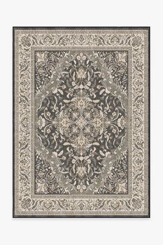 a rug with an ornate design on the center and sides, in dark grey tones