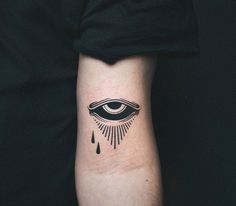 an eye tattoo on the left inner arm