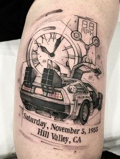 the back of a man's leg with a car and clock tattoo on it