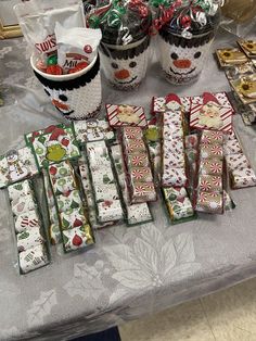 many candy bars are lined up on a table with christmas wrappings and candies