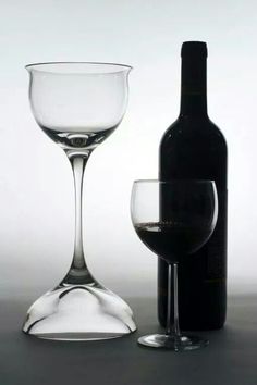 a wine glass and bottle sitting next to each other