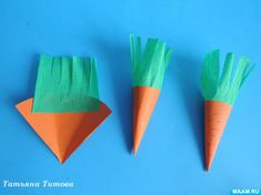 three carrots made out of green and orange paper