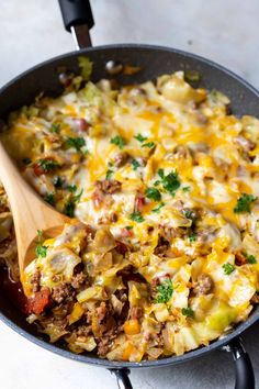 a skillet filled with cheese and meat