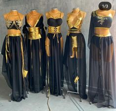 four different types of dresses on mannequins with gold accents and black fabric