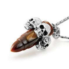 ORIGINSouth Africa HARDNESS7 NATURAL100% Natural This bewitching skull pendant showcases a gold tiger's eye Carved Bullet, four attractive silver skulls sitting around. Classic pointed bullet pendant with silver skulls design, follows the trend will not be outdated. Sterling Silver Skull Jewelry With Polished Finish, Skulls Design, Carved Skull, Gold Tiger Eye, Bullet Necklace, Skull Pendant Necklace, Skull Bracelet, Skull Carving, Skull Jewelry