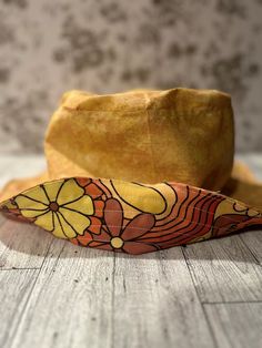 a yellow hat sitting on top of a wooden table