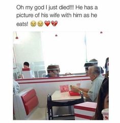 two people sitting at a table in a restaurant with red and white striped booths on them