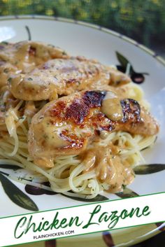 a plate with pasta and meat covered in sauce