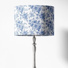 a blue and white lamp on a table